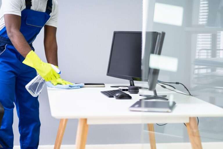 man cleaning desk in office